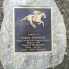 Brass memorial plaque dedicated to Lucky Debonair at Danada Equestrian Center in Wheaton, Illinois.