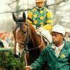 Summer Squall and Pat Day, led by groom Willie Wood. Photo courtesy of The Blood-Horse.